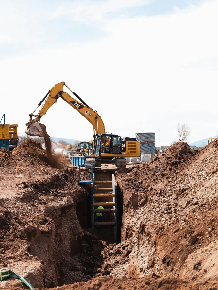 Excavator digging a trench on a civil works site